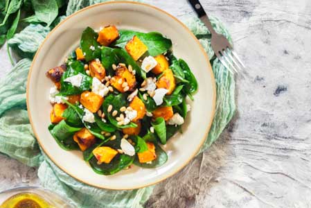Roasted pumpkin salad with spinach, feta and pine nuts