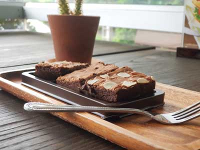 Dark chocolate brownies topping with almond slices